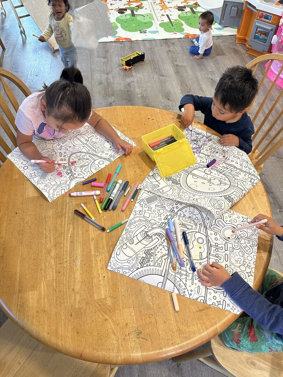 Children coloring at the art table
