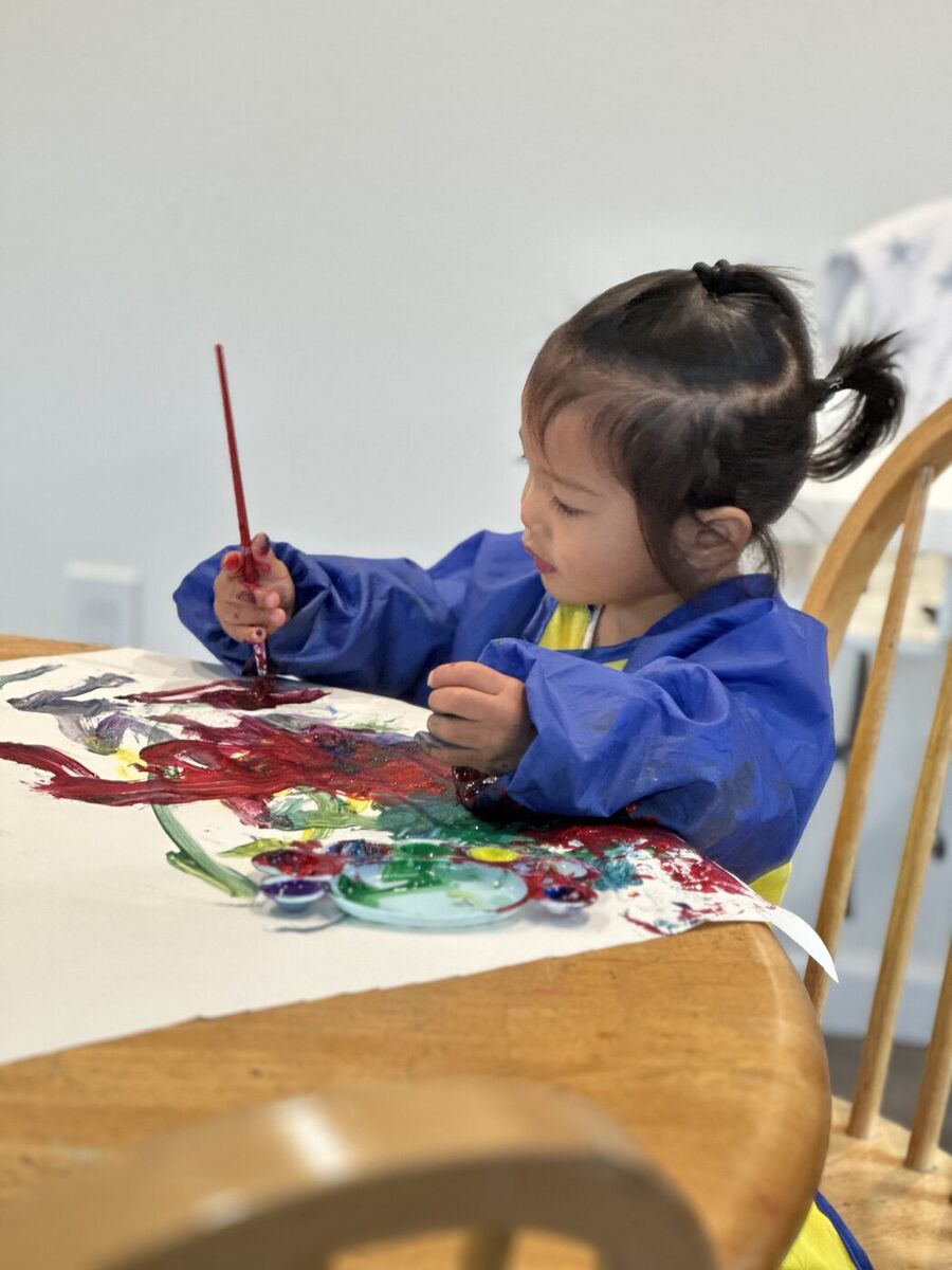 A child focused on a colorful watercolor painting